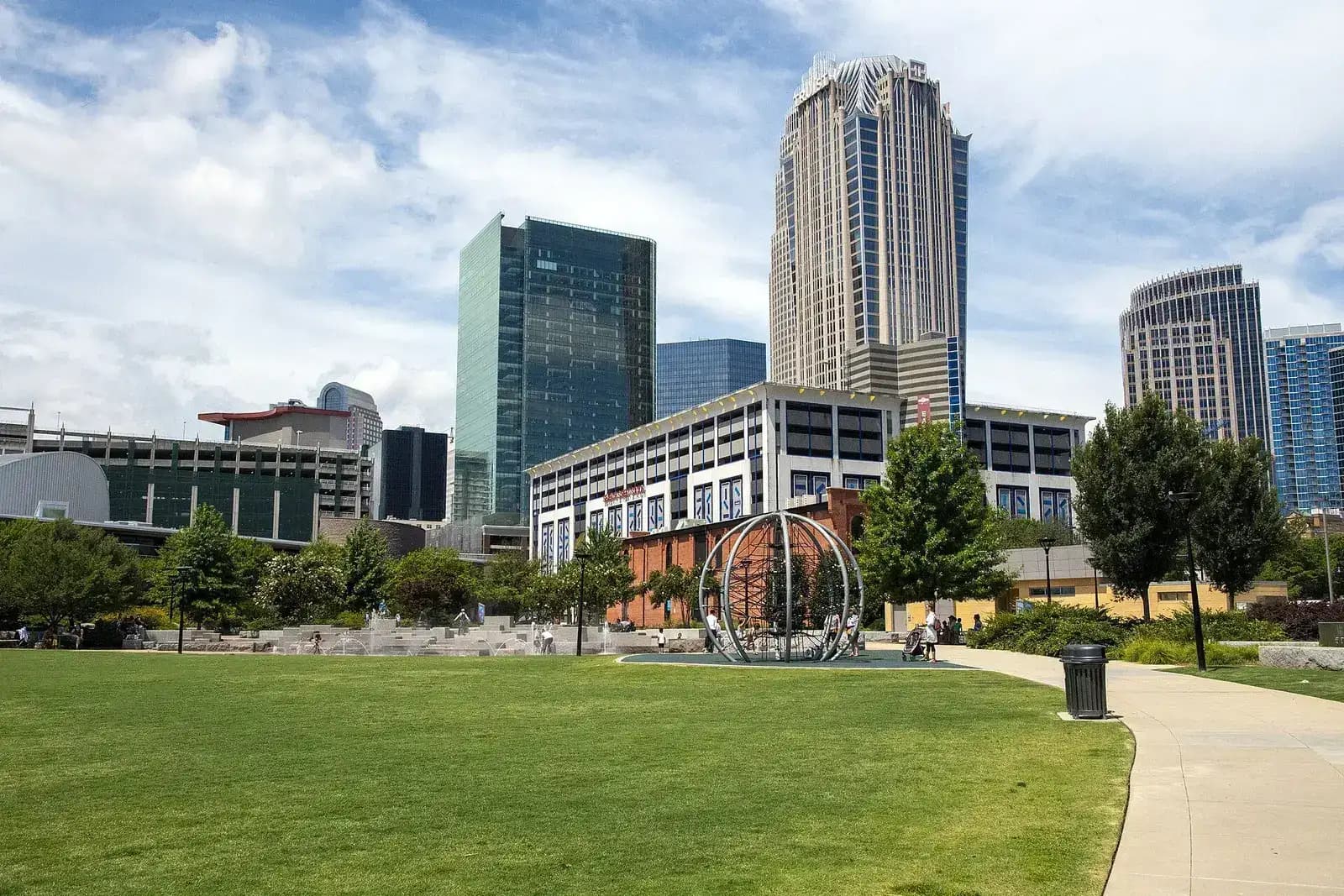 Lawn and walkway in front of Uptown Charlotte office towers on a sunny day
