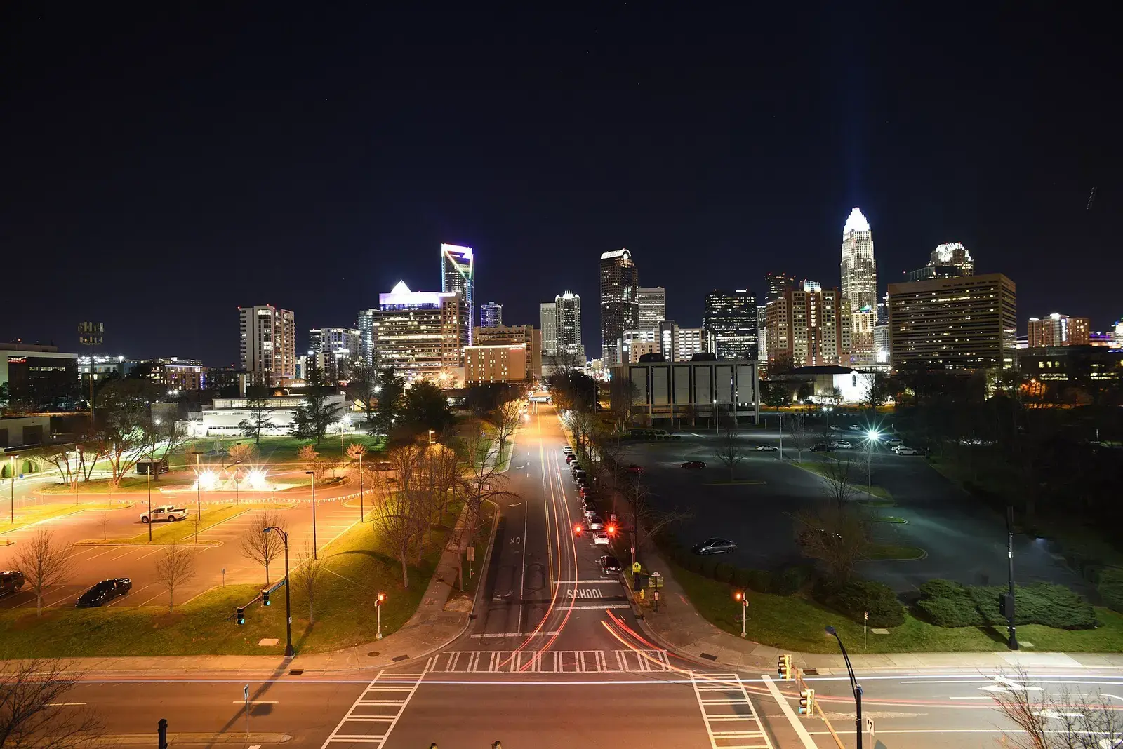 Charlotte skyline at night above a lit street