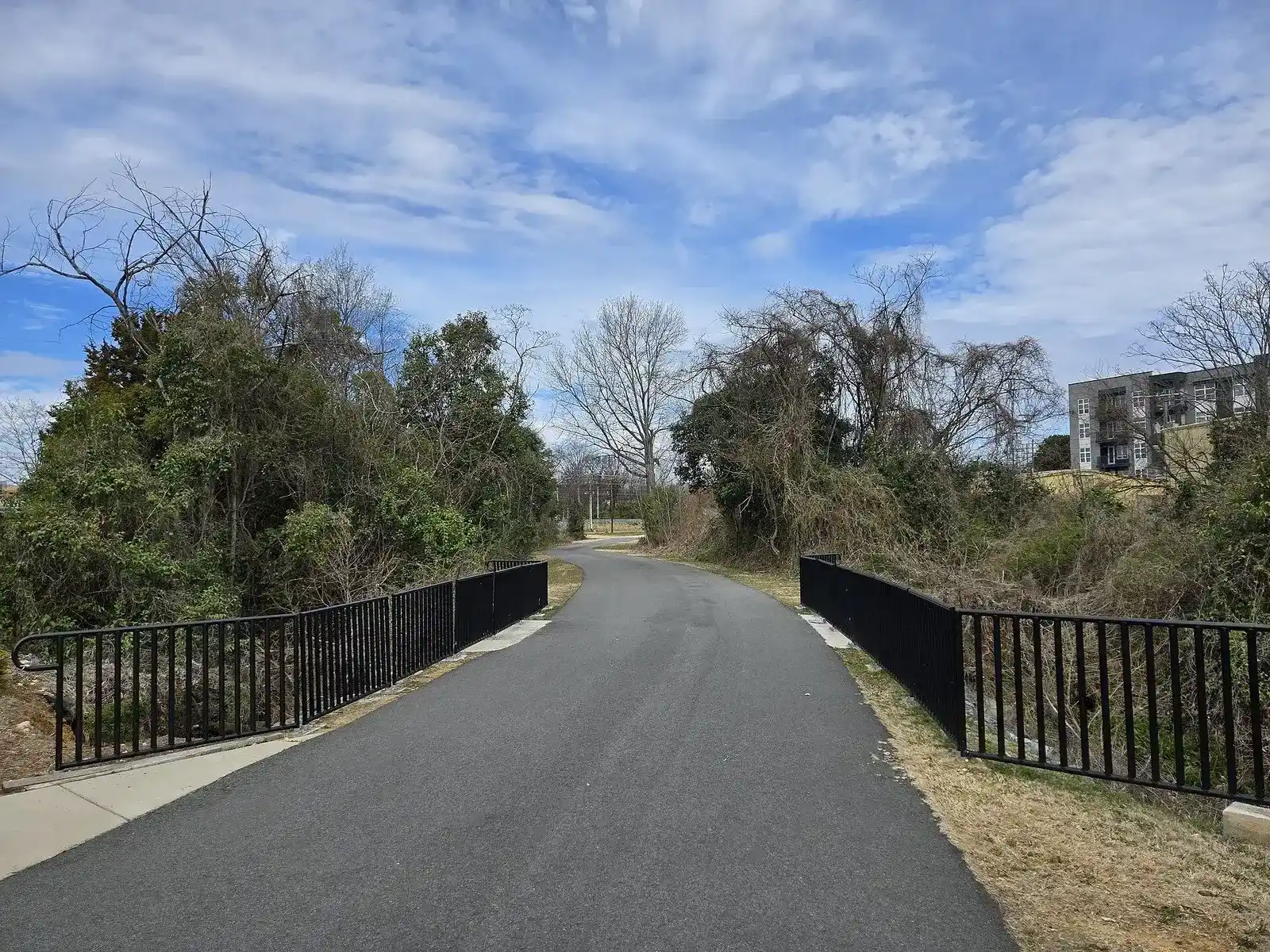 Paved Little Sugar Creek Greenway path crossing a bridge in Charlotte