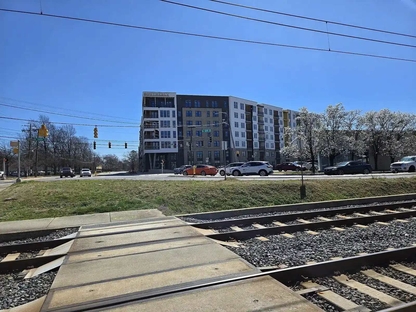 Mid-rise building across the light rail tracks along Old Pineville Road in Charlotte