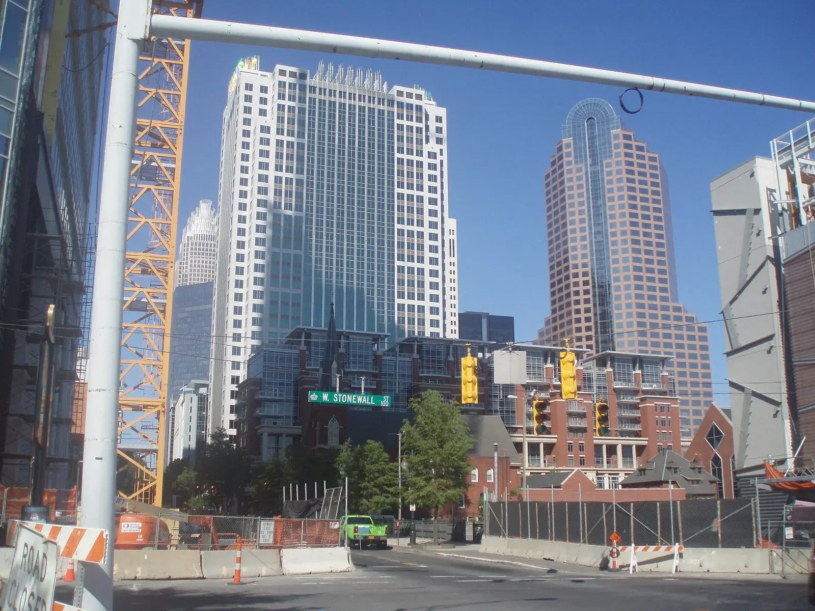 Uptown Charlotte towers seen from a street with construction fencing