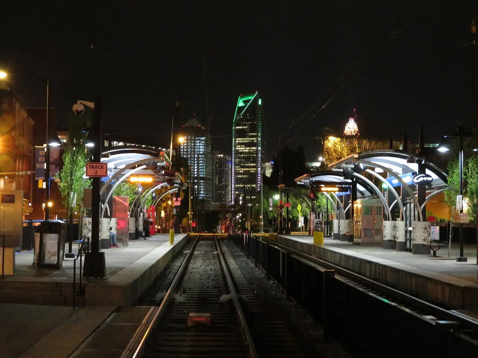 South End light rail station lit at night with Uptown Charlotte towers behind