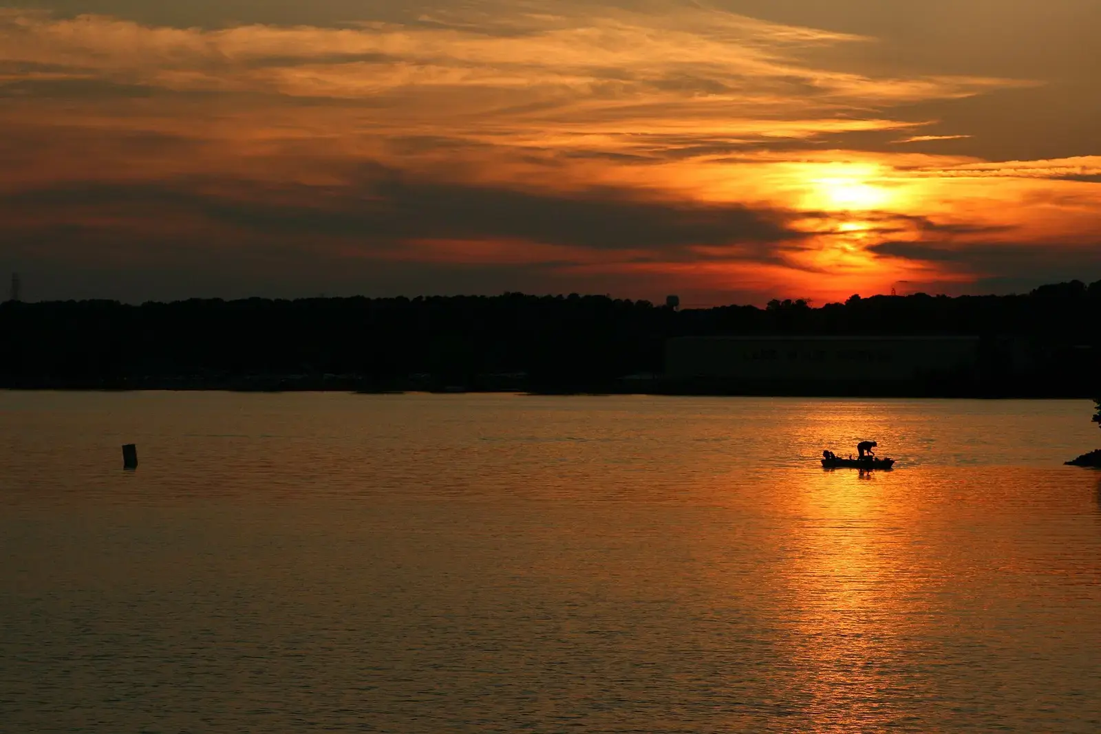 Orange sunset over Lake Wylie with a boat on the water