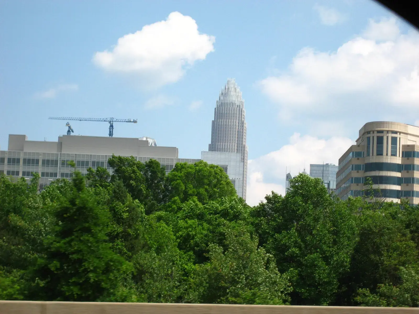 Bank of America Corporate Center tower above trees in Uptown Charlotte