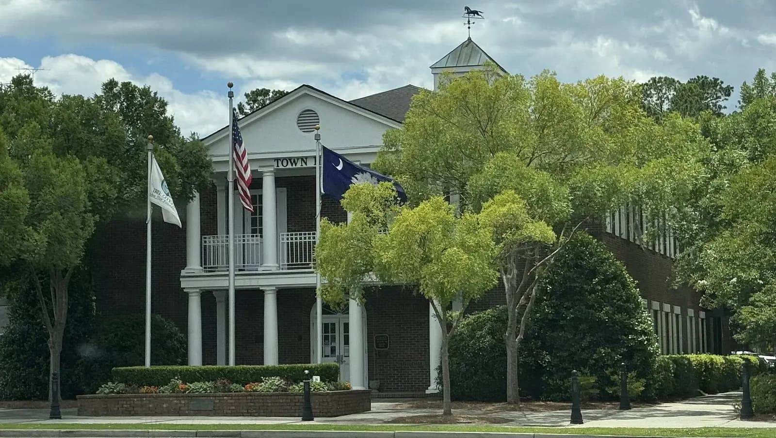Summerville Town Hall with columns and flags in Summerville, South Carolina