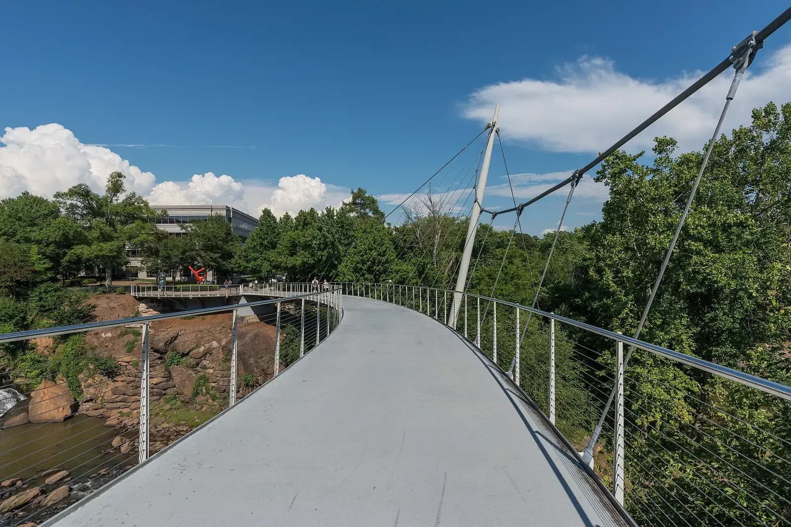 Curved Liberty Bridge pedestrian walkway at Falls Park on the Reedy in Greenville, South Carolina