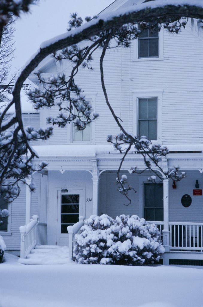 Suburban street after snowfall with tire tracks - winter weather in the neighborhood